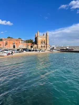 a view of the water with a church in the background at Una Finestra sul Mare in Palermo