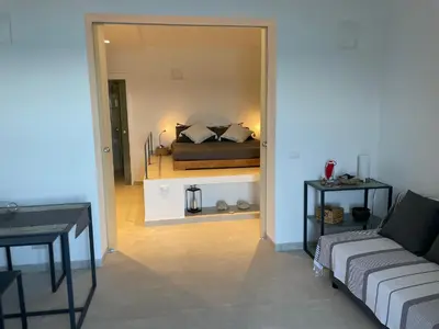 a living room with a couch and a bed at Una Finestra sul Mare in Palermo
