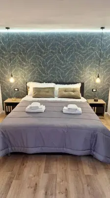 a bedroom with a large bed with two towels on it at Casa Salina Suite in Palermo