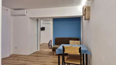 a dining room with a table and a blue wall at Casa Salina Suite in Palermo