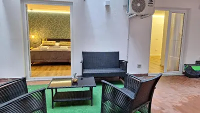 a living room with two chairs and a bed at Casa Salina Suite in Palermo