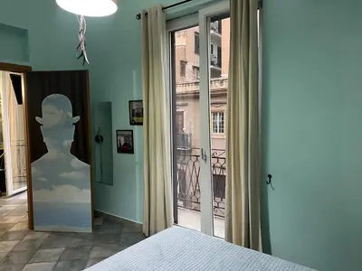 a bedroom with a window with a statue of a man at Le Stanze di Magritte in Palermo