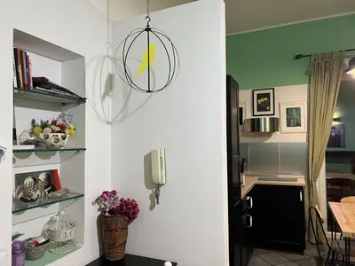 a kitchen with a door open to a kitchen with a table at Le Stanze di Magritte in Palermo