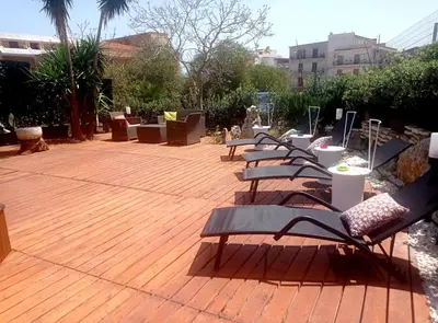 a row of benches sitting on a wooden deck at Casa Mary in Castellammare del Golfo
