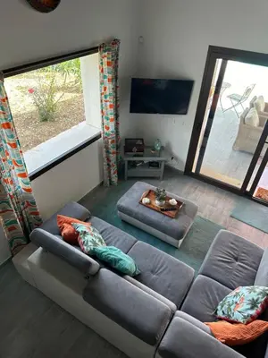 a living room with a couch and a large window at Stella Del Mare in Scopello