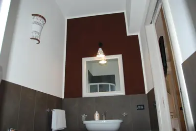 a bathroom with a sink and a mirror at Locanda Del Drago in Monreale