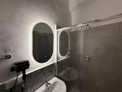 a bedroom with a bed and a couch and violet lights at monteleone centro apartment in Palermo