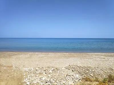 a rocky beach with the ocean in the background at Campofelice Holidays East Villa in Campofelice di Roccella