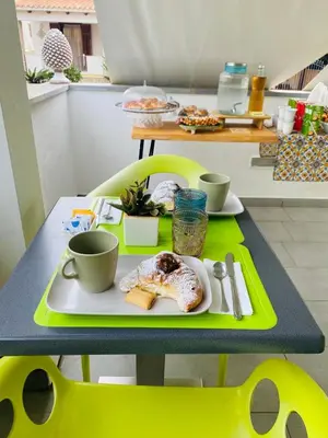 a table with a plate of food and two cups at B&b Diamond in San Vito lo Capo