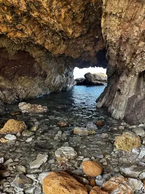 a cave with water and rocks in front of it at Casa Vacanze La Dolce Vita in Terrasini