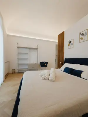 a bedroom with a large bed with towels on it at Butera 505-Luxury Suites in Bagheria