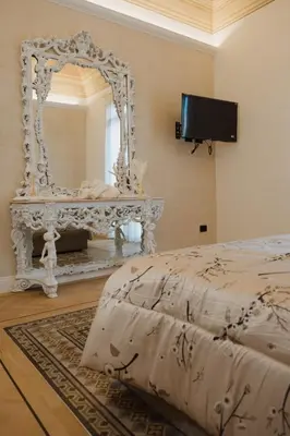 a bedroom with a white mirror and a bed at Butera 505-Luxury Suites in Bagheria