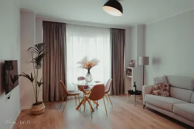 a living room with a table and chairs and a couch at Bloom Apartment 35 in Palermo