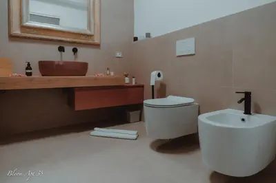a bathroom with a white toilet and a sink at Bloom Apartment 35 in Palermo