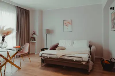 a bedroom with a bed and a desk and a table at Bloom Apartment 35 in Palermo