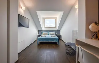 a attic room with a bed and a window at Amazing Home In Balestrate With Wifi in Balestrate