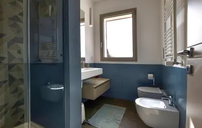 a bathroom with a toilet and a sink and a mirror at Amazing Home In Balestrate With Wifi in Balestrate