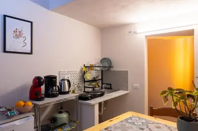 a small kitchen with a stove and a table at Normanni Underground in Palermo