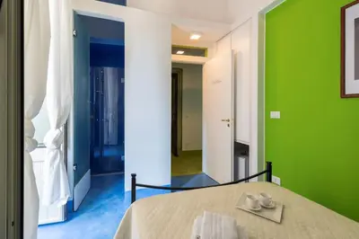 a bedroom with green and blue walls and a bed at Olivella 11 in Palermo