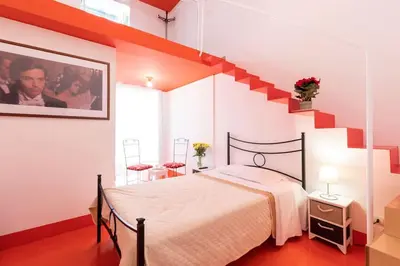 a bedroom with a large bed and a staircase at Olivella 11 in Palermo