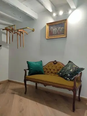 a couch in a room with a painting on the wall at Liberty Green House in Palermo