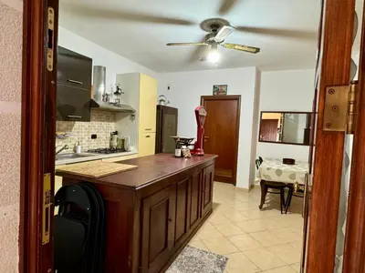 a kitchen with a counter and a ceiling fan at Civico 22 Casa Vacanza in Torretta