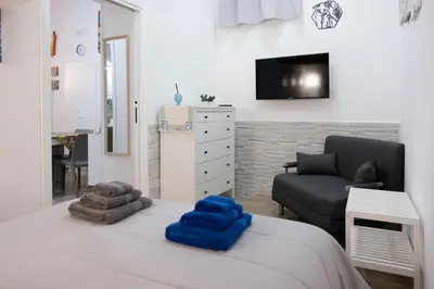 a bedroom with a bed with blue towels on it at Tra i vicoli di Ballarò in Palermo