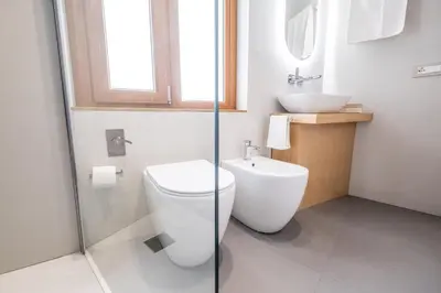 a bathroom with a toilet and a sink at Teatro Apartments Villafranca in Palermo