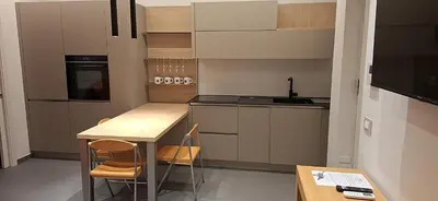 a kitchen with a counter and a table and chairs at Teatro Apartments Villafranca in Palermo