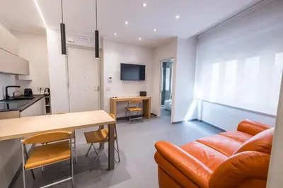a living room with a couch and a table at Teatro Apartments Villafranca in Palermo
