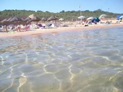 a view of a beach with people and umbrellas at Casa Vacanze Nicole in Balestrate
