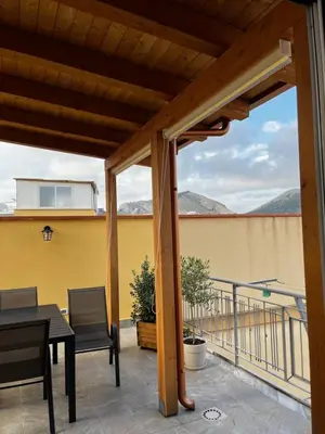 a patio with a table and chairs on a balcony at La Terrazza di Nela in Bagheria