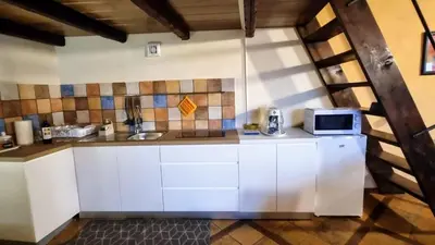 a kitchen with white cabinets and a microwave at Casale di Sicilia in Monreale