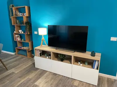 a living room with a flat screen tv on a white entertainment center at Quintino Sella 41 Apartment in Palermo