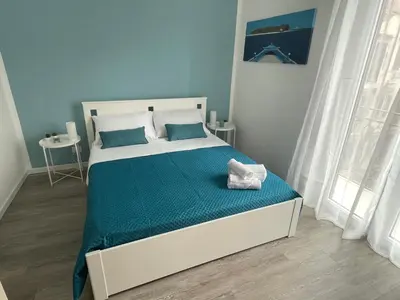a bedroom with a bed with a blue and white at Quintino Sella 41 Apartment in Palermo