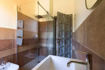 a bathroom with a shower and a sink and a tub at Villa Guidaloca Cala Bianca in Castellammare del Golfo