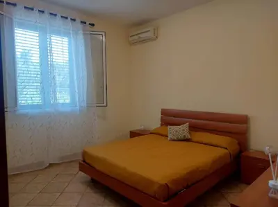 a bedroom with a bed and a window at Il giardino degli ulivi in Trabia