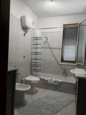 a bathroom with a toilet and a sink at Il giardino degli ulivi in Trabia