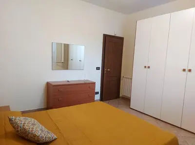 a bedroom with a bed and a dresser and a mirror at Il giardino degli ulivi in Trabia