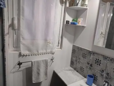 a bathroom with a shower curtain and a sink at La Casetta al Cassaro in Palermo