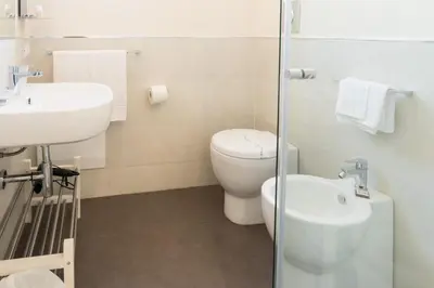 a bathroom with a toilet and a sink at B&B Cannoli in Palermo