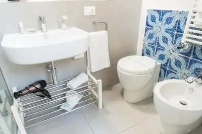 a bathroom with a sink and a toilet at B&B Cannoli in Palermo