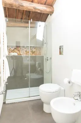 a bathroom with a shower and a toilet and a sink at B&B Cannoli in Palermo
