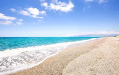 a beach with the ocean and a blue sky at 1 Bedroom Stunning Home In Partinico in Partinico
