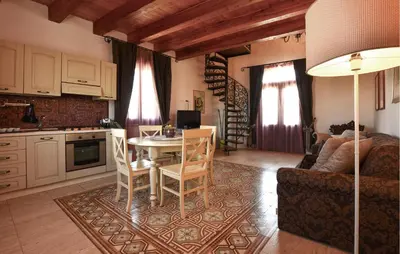 a kitchen and living room with a table and chairs at 1 Bedroom Stunning Home In Partinico in Partinico