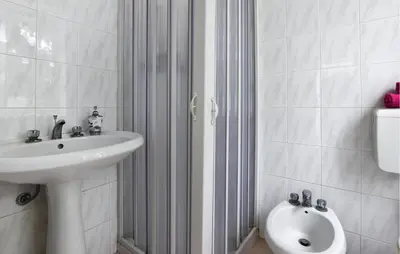 a white bathroom with a sink and a toilet at Gorgeous Apartment In Capaci With Wifi in Capaci