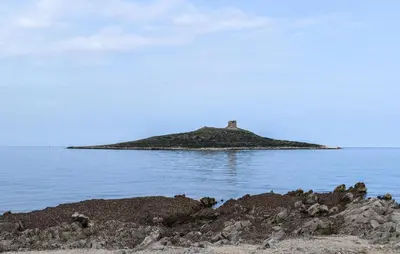 an island in the water with a lighthouse on it at Gorgeous Apartment In Capaci With Wifi in Capaci