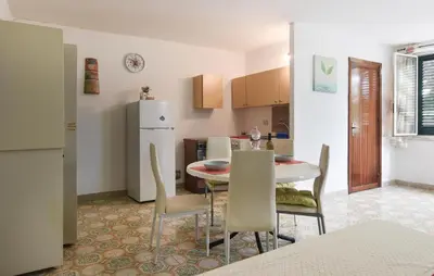 a kitchen and dining room with a table and chairs at Gorgeous Apartment In Capaci With Wifi in Capaci