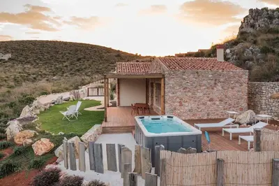 a stone house with a swimming pool in a yard at Villa Zingaro Cala Bianca in Castellammare del Golfo