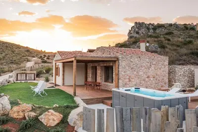 a villa with a swimming pool and a house at Villa Zingaro Cala Bianca in Castellammare del Golfo